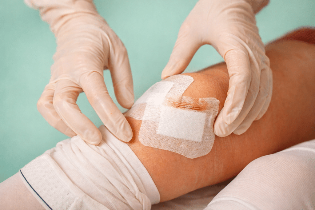 Medical provider treating a knee wound